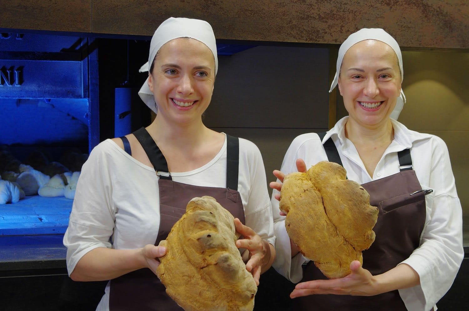 Patrizia and Sabrina Perrone holding fresh Pane di Matera