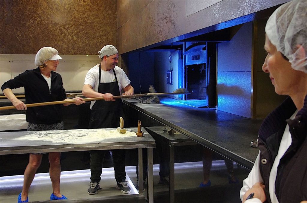 Guests baking Pani di Matera bread with baker Enzo at Il Forno di Gennaro in Matera