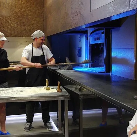 Guests baking Pani di Matera bread with baker Enzo at Il Forno di Gennaro in Matera