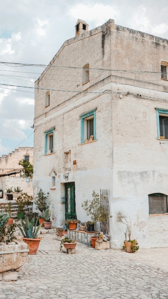 Residential buildings with blue-green shutters in the Sassi of Matera