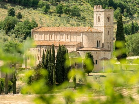 The Romanesque Abbey of Sant'Antimo set in olive groves near Montalcino