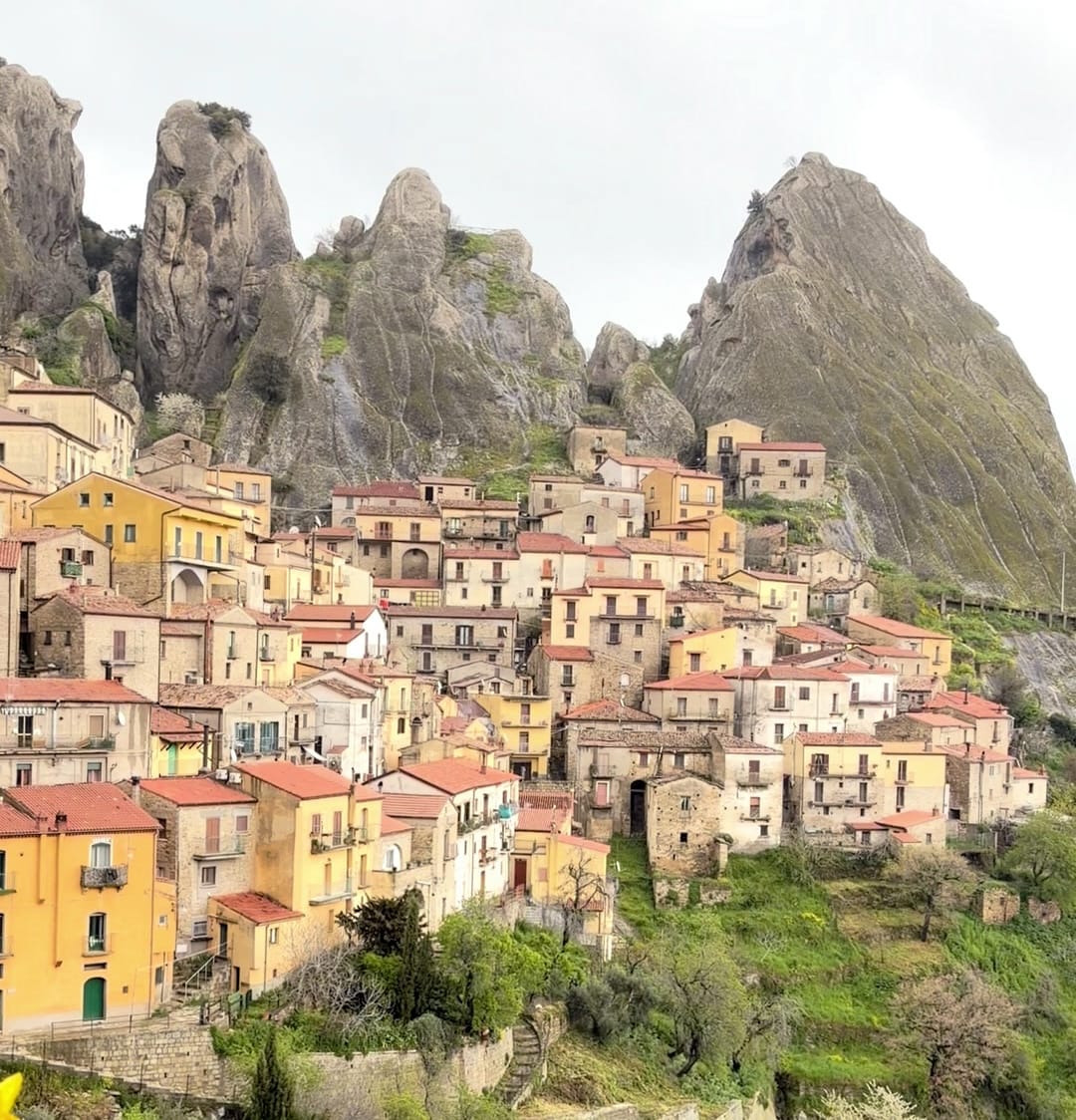 The village of Castelmezzano clinging beneath the sharp sandstone spires of the Dolomiti Lucane