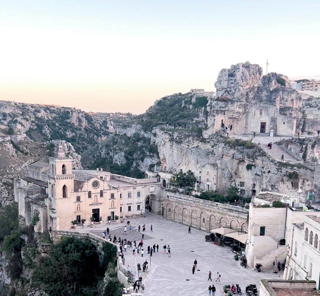 Piazza San Pietro Caveoso and the canyon of Matera at dusk