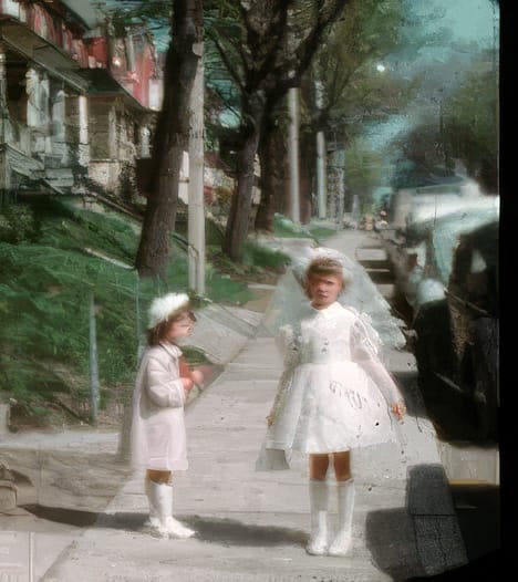 Adele in her first communion dress with her little sister Micki on a Toronto sidewalk