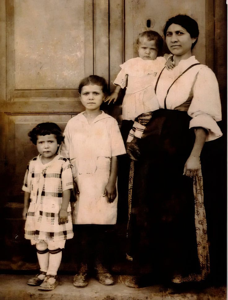 Sepia 1927 studio portrait: Nonna Michelina holding baby Anna, with her daughters Rosa and Camilla