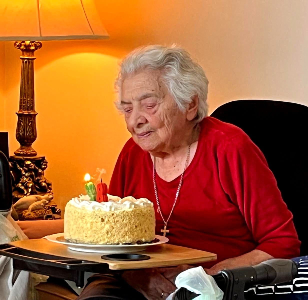 My mother, Anna, seated with a birthday cake