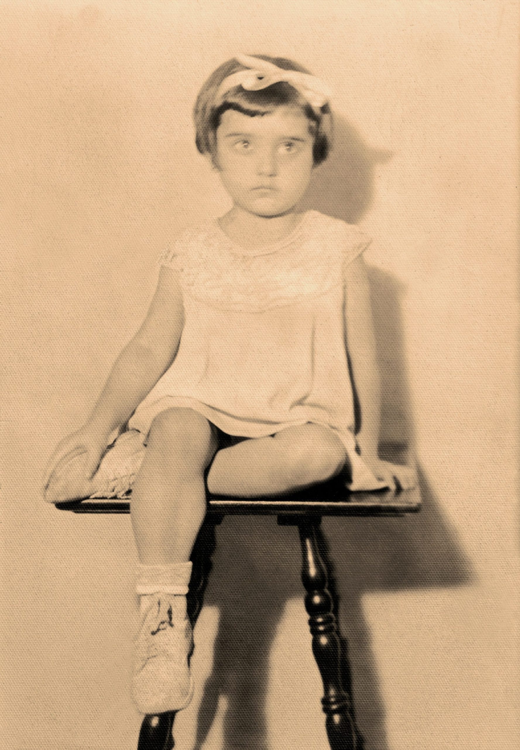 Carol's mother as a little girl, seated on a stool